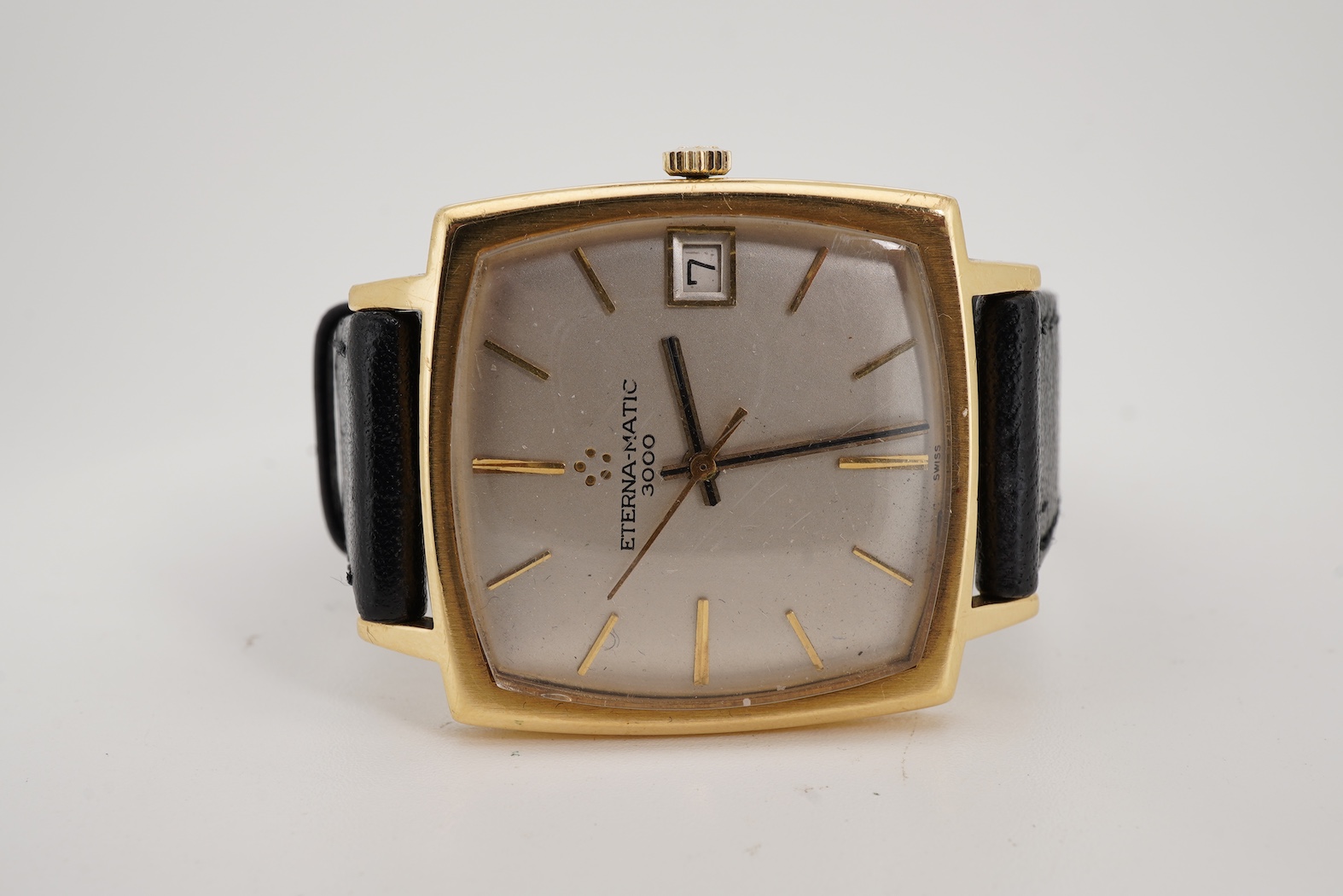 A gentleman's 18ct gold Eterna-Matic 3000 wrist watch, with baton hour marker, centre seconds hand and calendar aperture at 3 o’clock, on an associated black leather strap